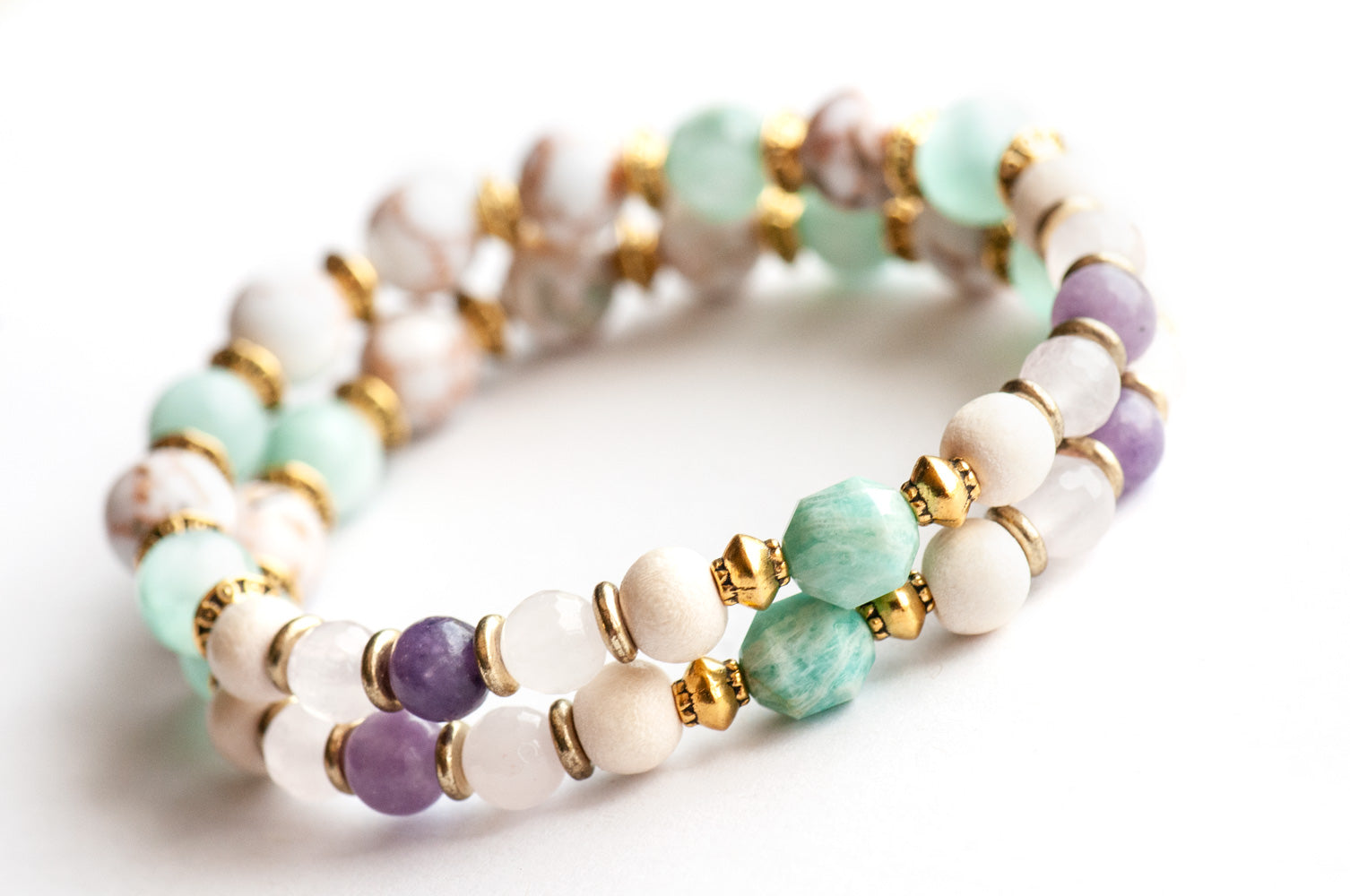 Supporting bracelets in Art Nouveau Lynx set showing Amazonite prisms, Rose Quartz, and Angelite cat’s eye beads