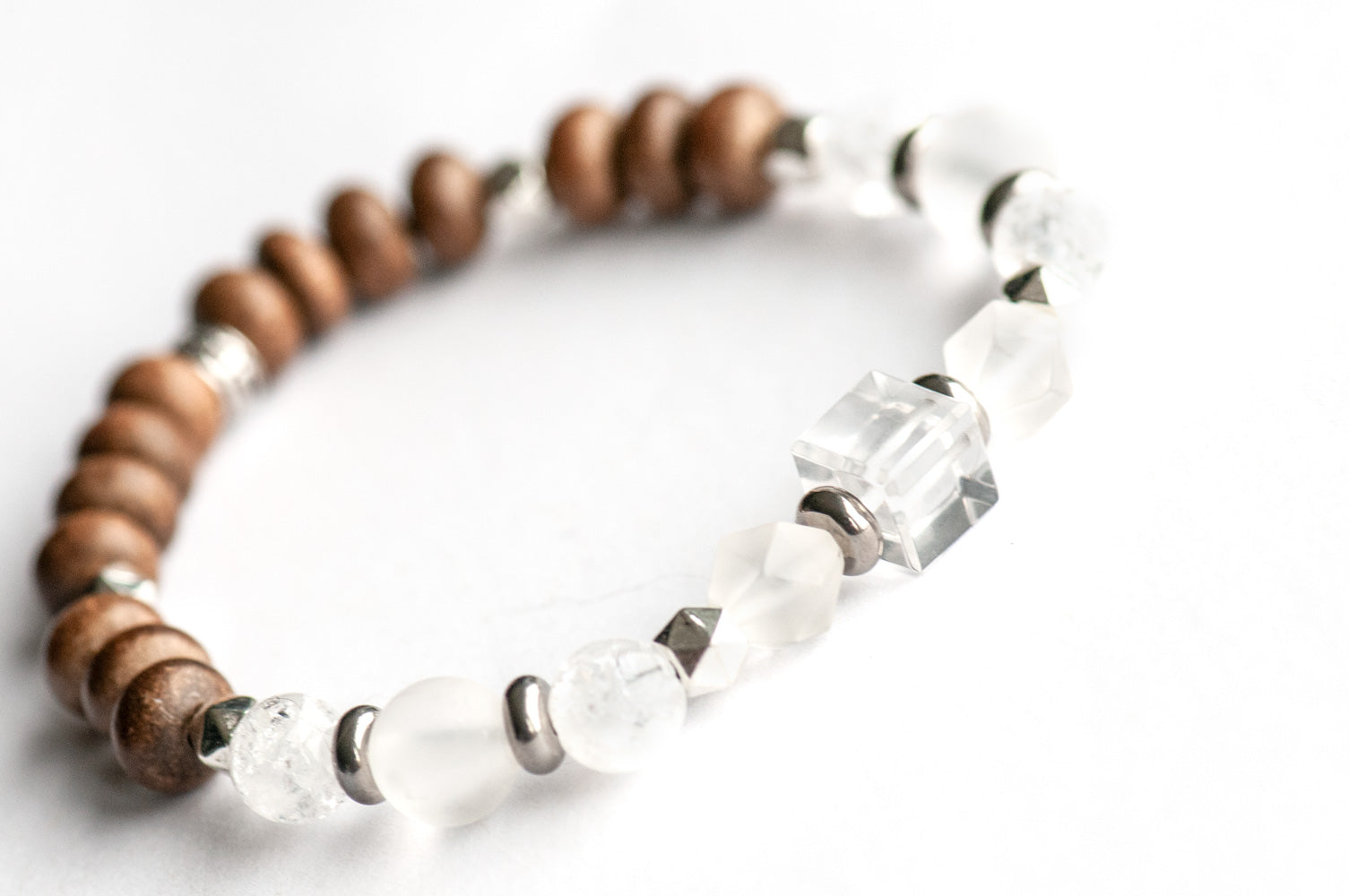 Feature bracelet from Northwest Territories Lynx Set – Crystal Quartz cube with frosted and crackle quartz rounds, grey wood beads, and silver spacers