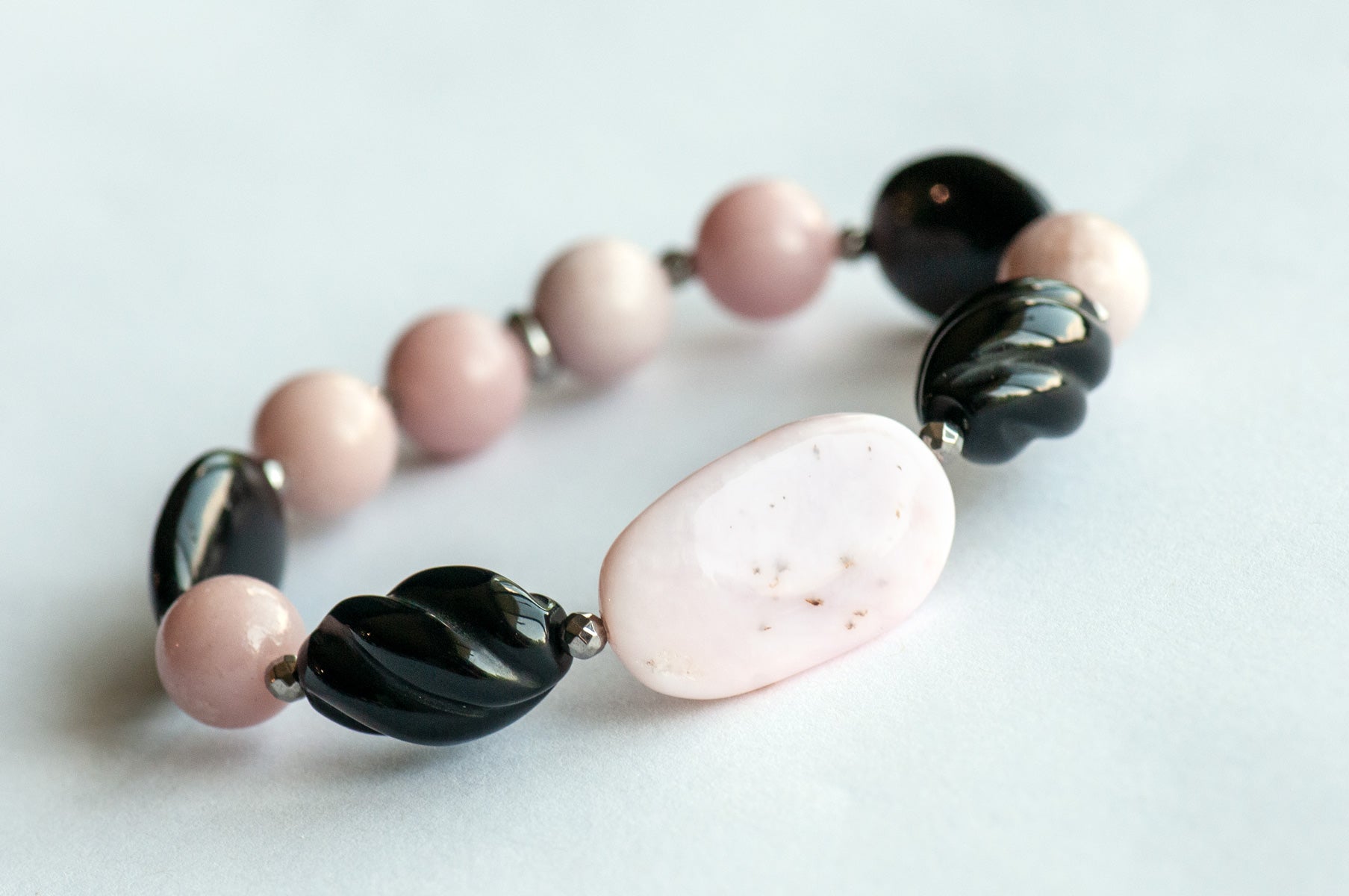 Close-up of Pink Opal and Black Onyx Beads in Bracelet Set