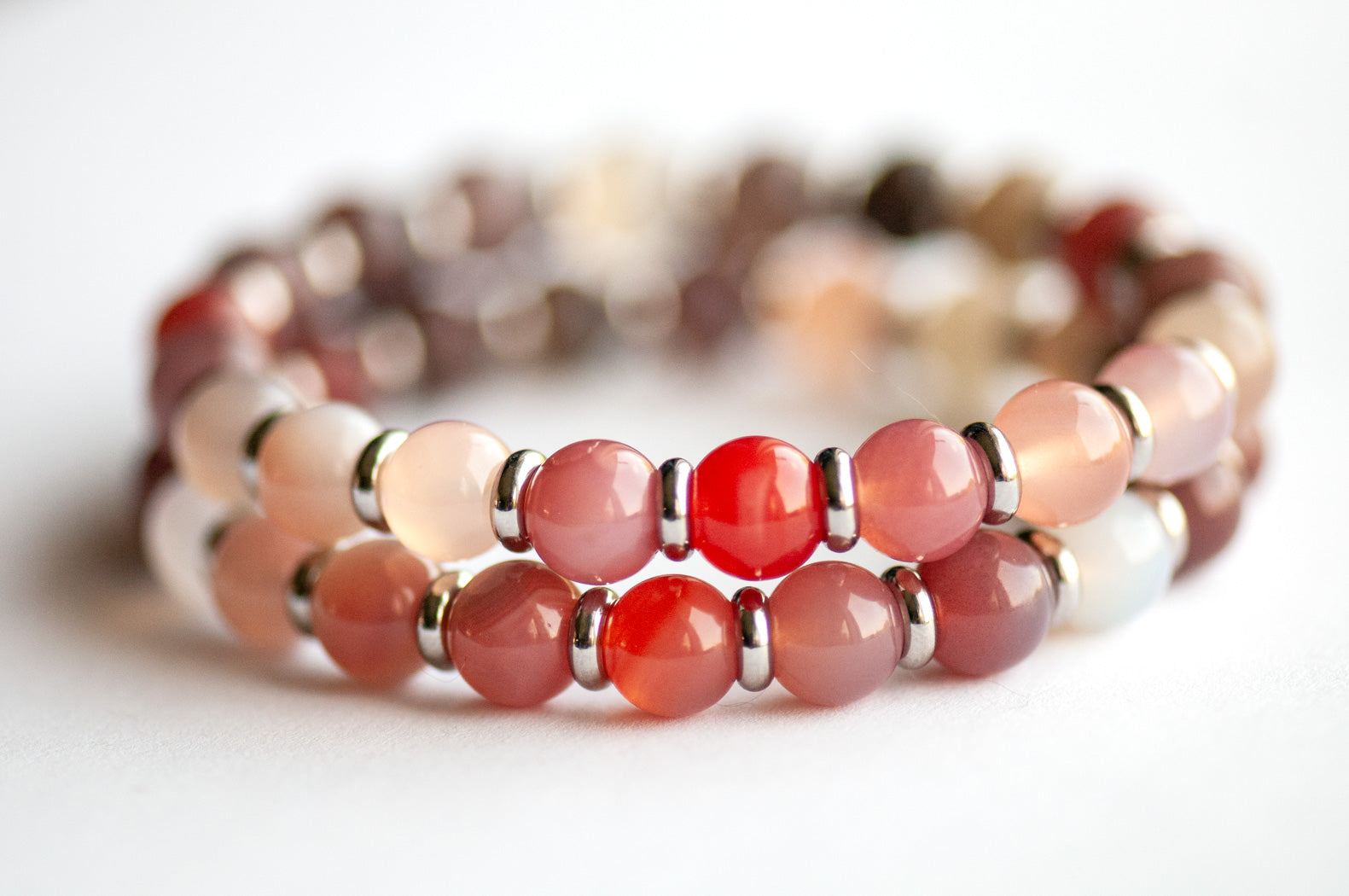 Close-up of Phantom Agate gradient beads in pink, mauve, and salmon tones