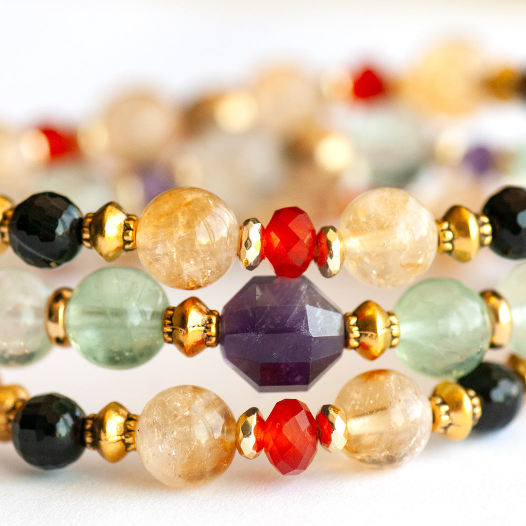 Close-up of Symbolist Lynx focal bracelet with pale green Fluorite and faceted Amethyst beads