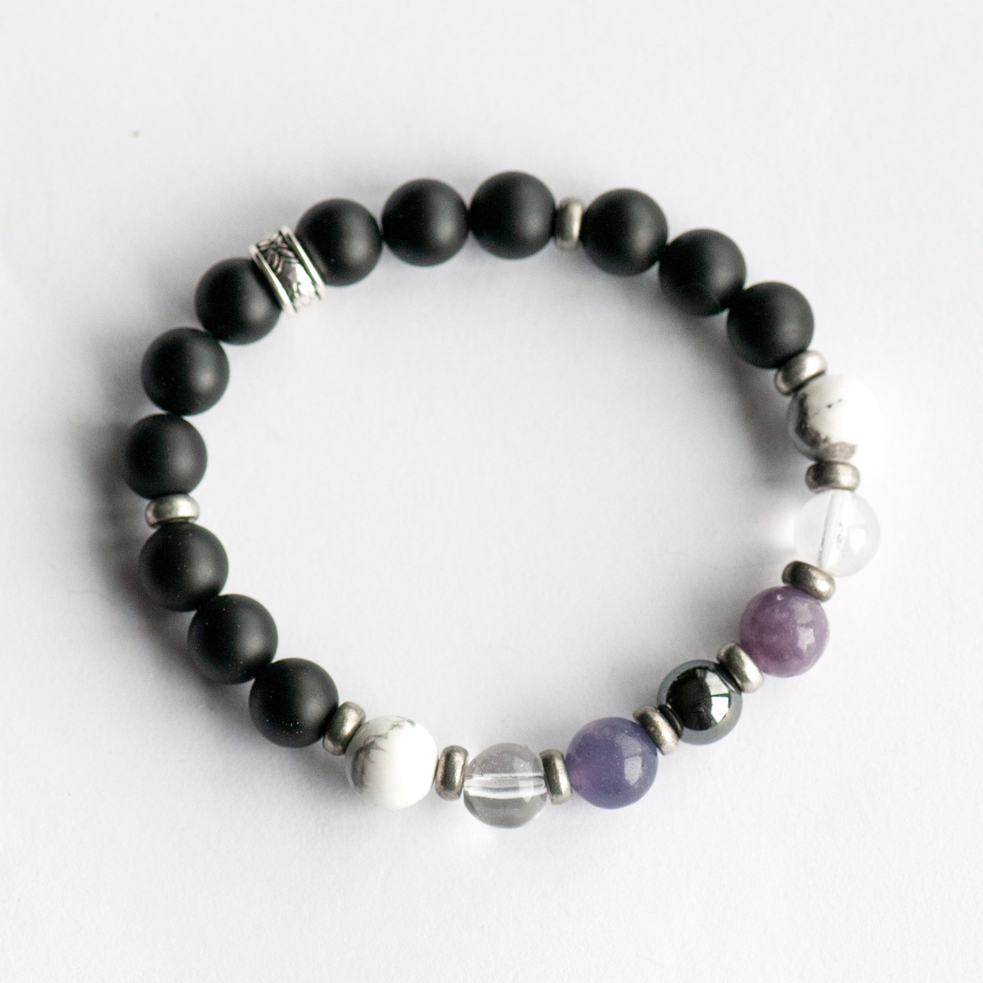Fierce Slumber bracelet with Hematite, Lepidolite, Howlite, and Frosted Black Agate on white background