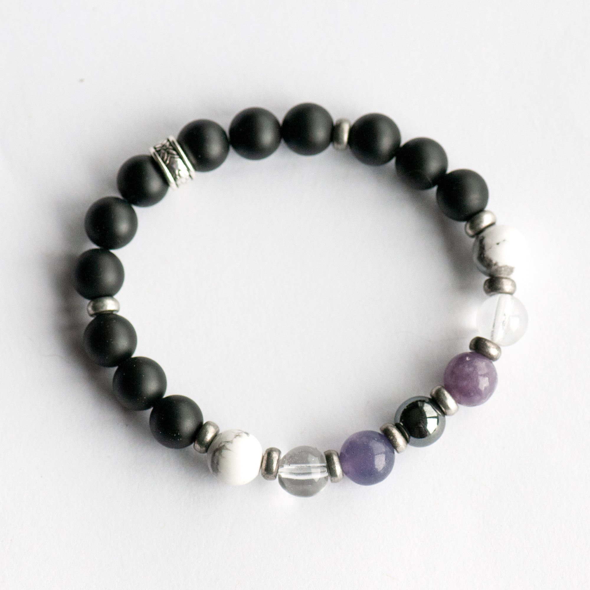 Fierce Slumber bracelet with Hematite, Lepidolite, Howlite, and Frosted Black Agate on white background