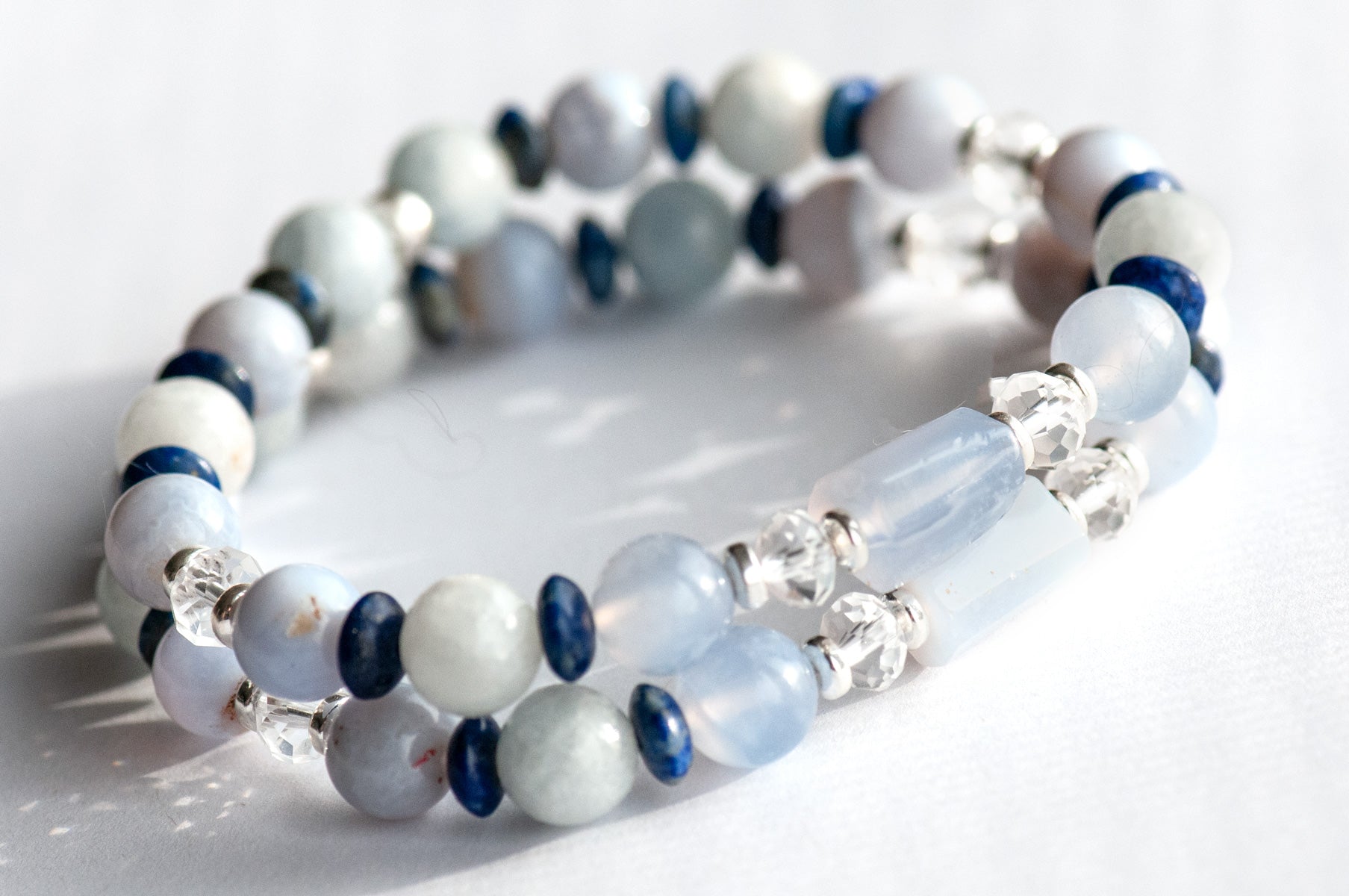 Handmade supporting bracelets featuring AAA-grade blue lace agate tubes and rounds with celestite, lapis lazuli accents, and crystal quartz rondelles