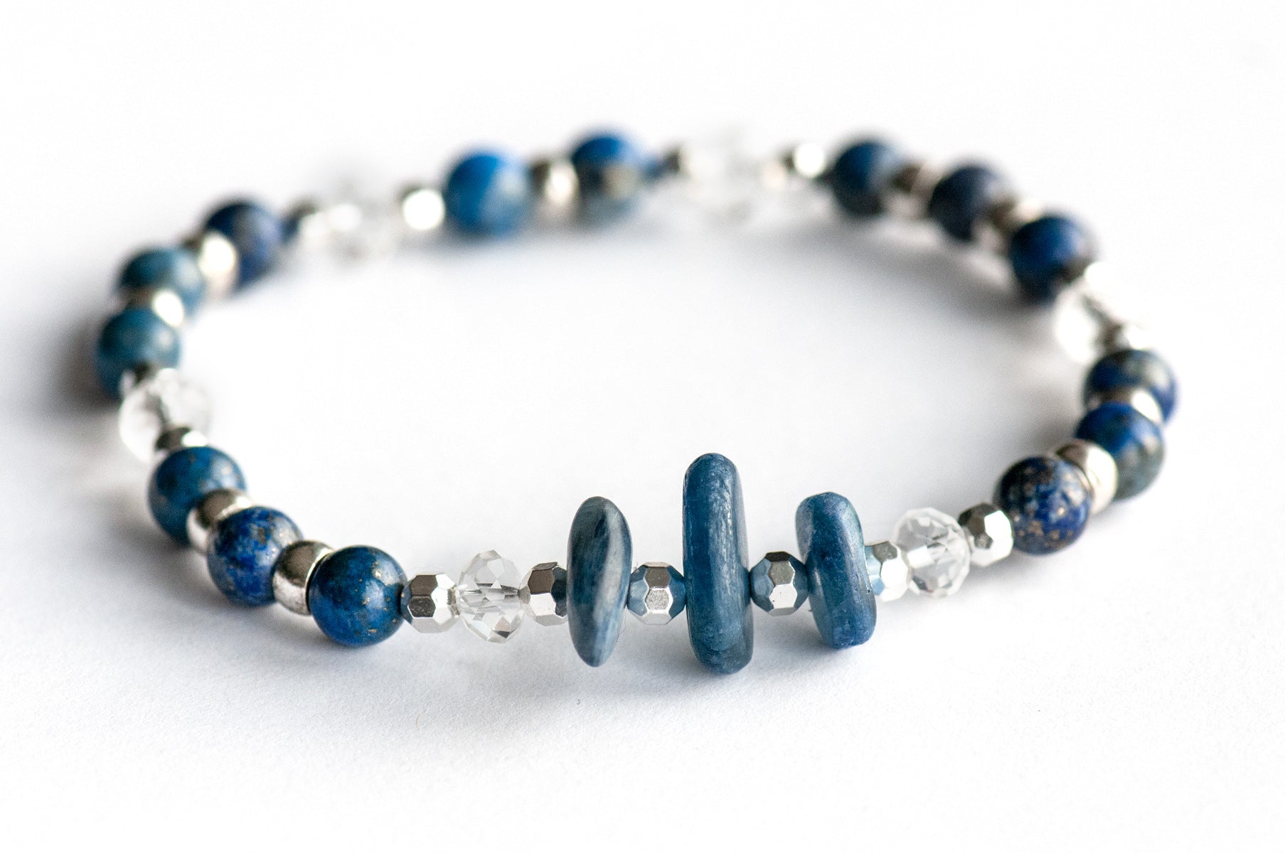 Handmade focal bracelet with irregular blue kyanite chips, faceted crystal quartz rondelles, and natural pyrite-flecked lapis lazuli rounds