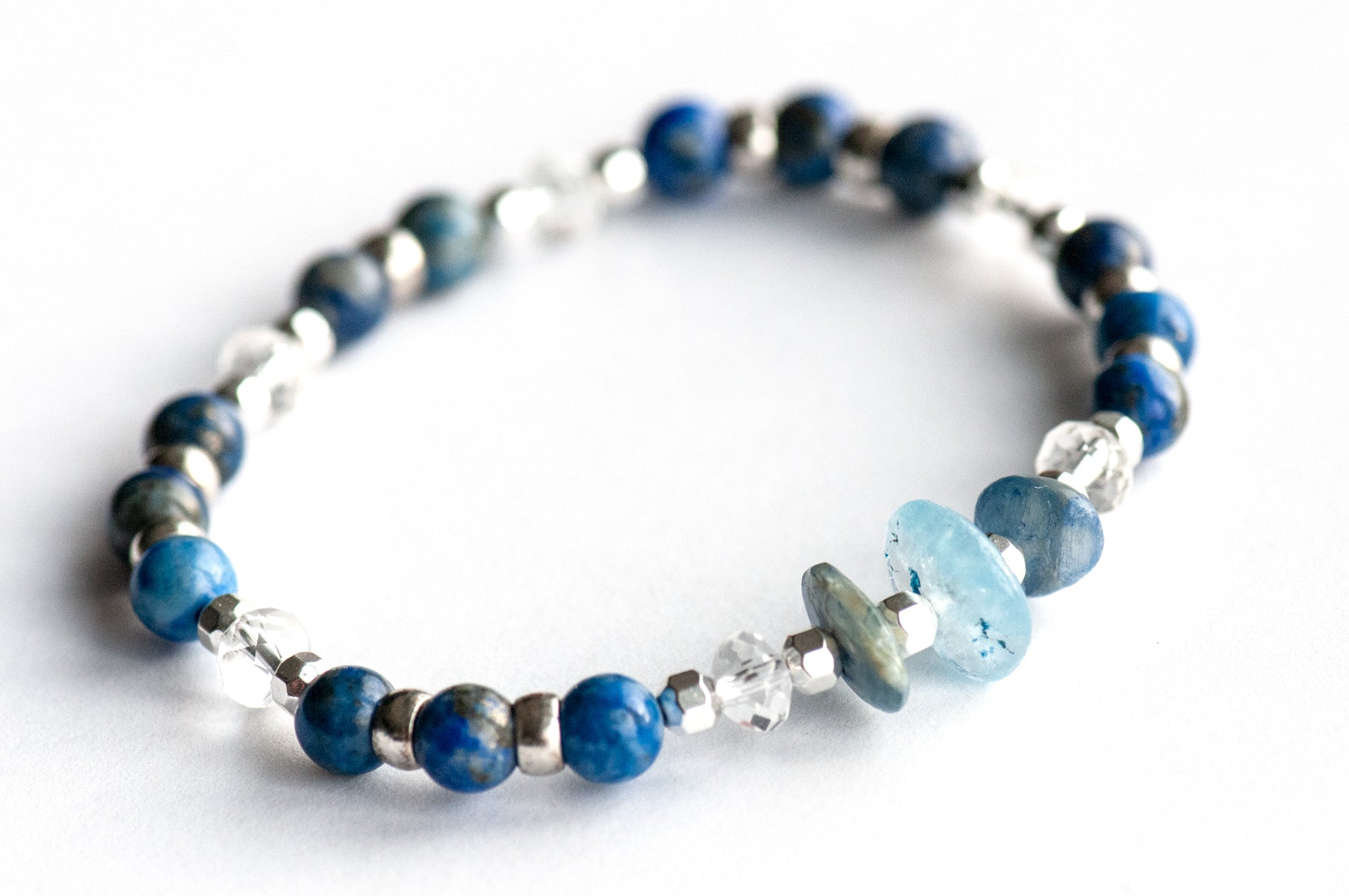 Handmade focal bracelet with irregular blue kyanite chips, faceted crystal quartz rondelles, and natural pyrite-flecked lapis lazuli rounds