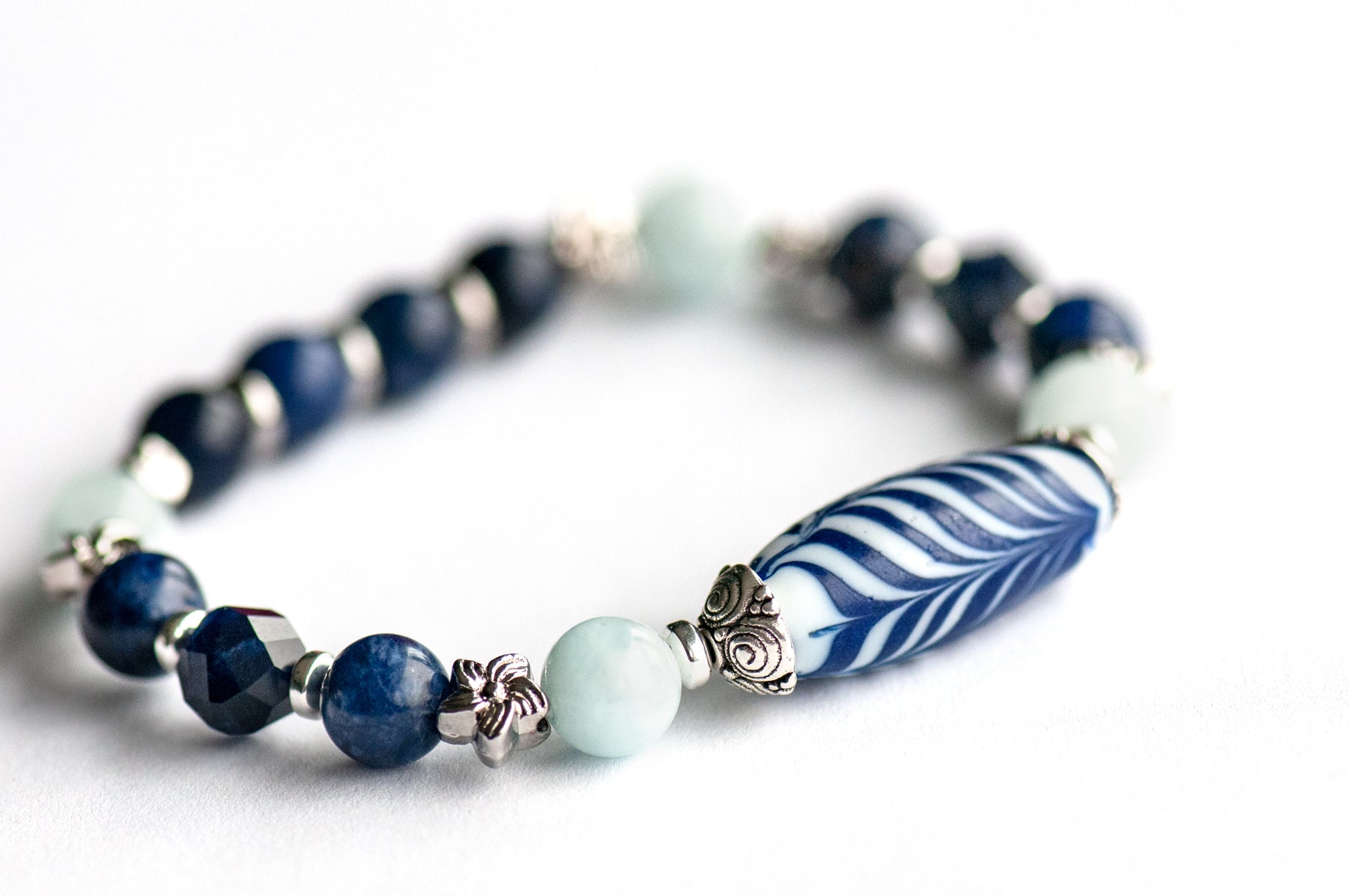Larkspur focal Bracelet: Aquamarine, Sodalite & a handmade glass feather bead celebrate July's birth flower — open-hearted, light, and full of summer grace.