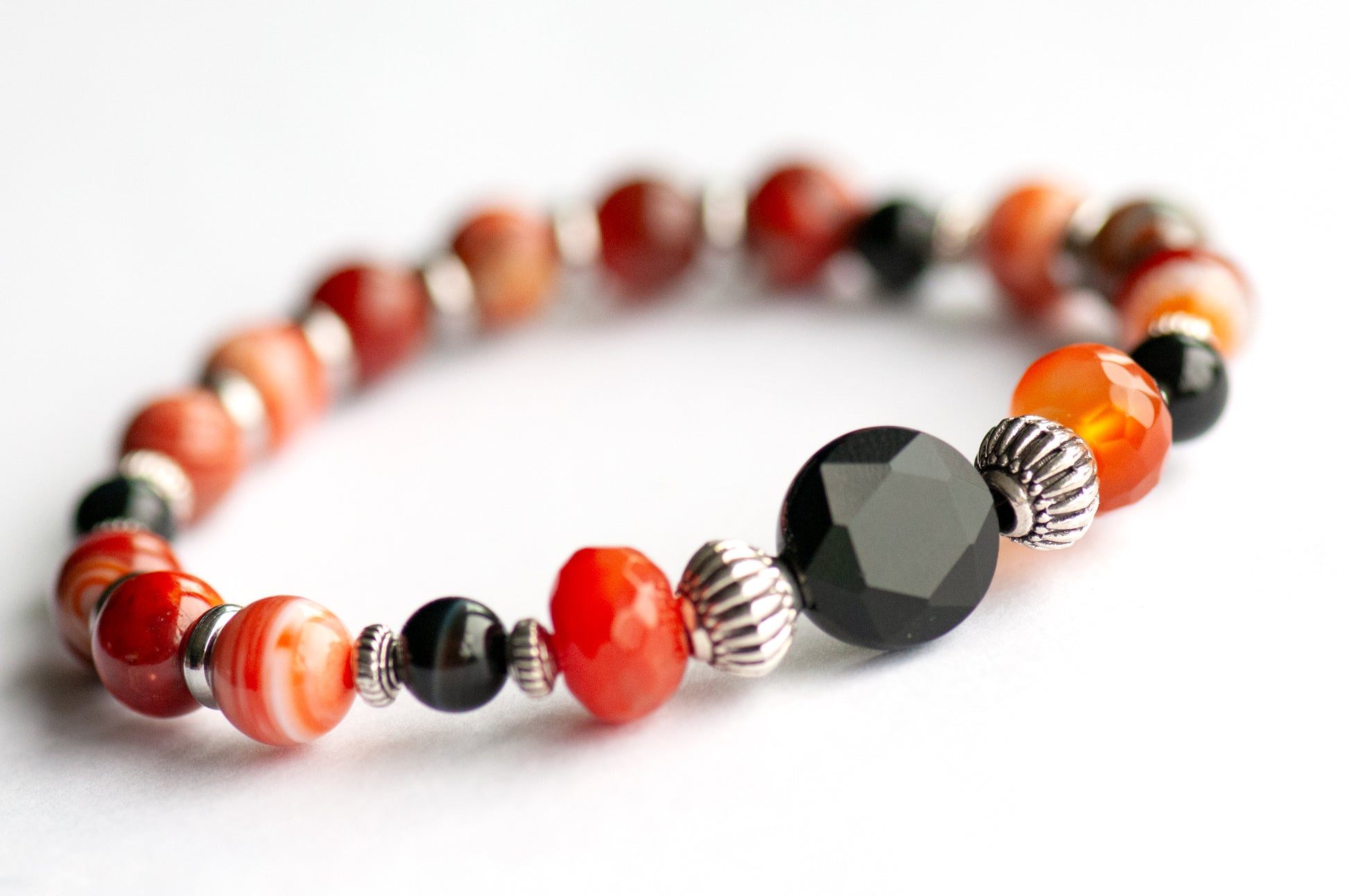 Poppy focal bracelet: Black Onyx, Red Agate & Flower Poppy Jasper celebrate August's birth flower — bold resilience in deep burnt reds and grounding black.