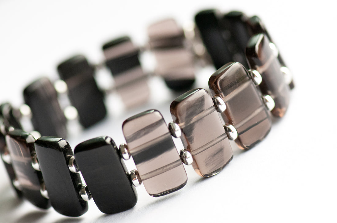 Ice Obsidian cuff bracelet — sleek black glass-like stone that reveals hidden streaks in the light. Handmade, ethically sourced, crafted in New Brunswick.