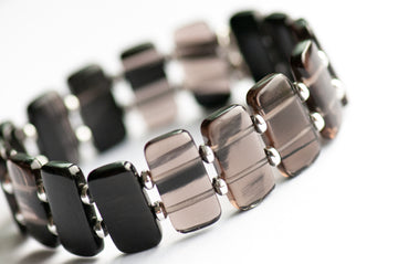 Ice Obsidian cuff bracelet — sleek black glass-like stone that reveals hidden streaks in the light. Handmade, ethically sourced, crafted in New Brunswick.