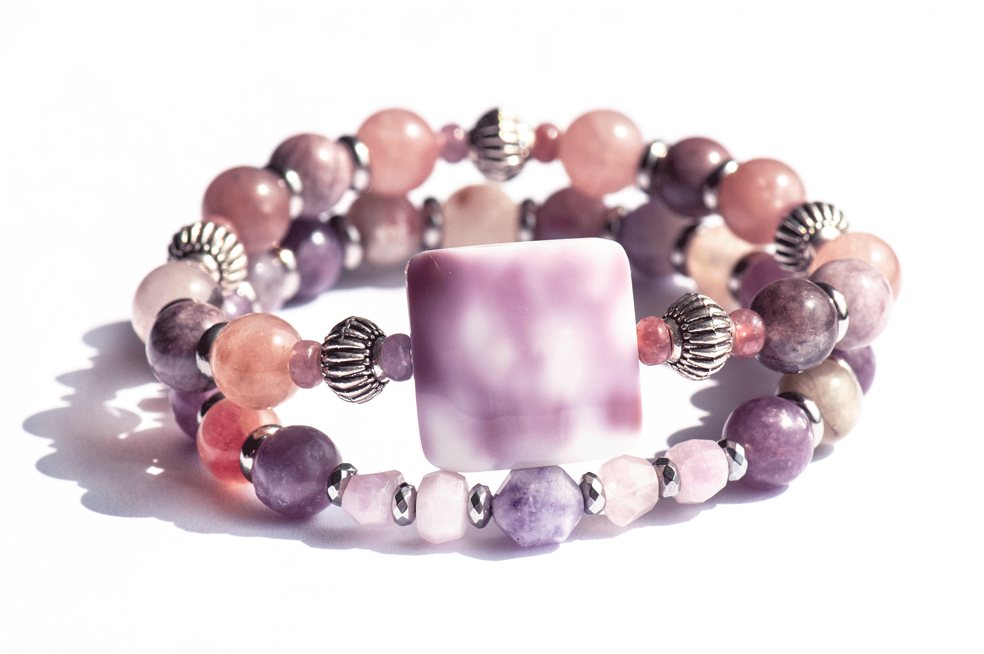 Aster September birth flower bracelet set — front view, two bracelets featuring purple cowrie shell, Berry Quartz, Mauve Jasper and Lepidolite in warm mauve tones