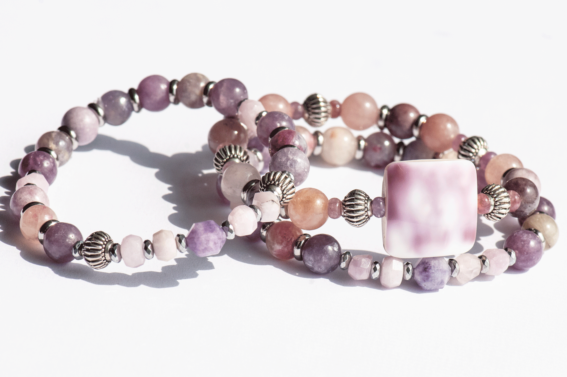 Aster September birth flower bracelet set — side view, triple stack showing full layered effect in warm mauves and soft purple