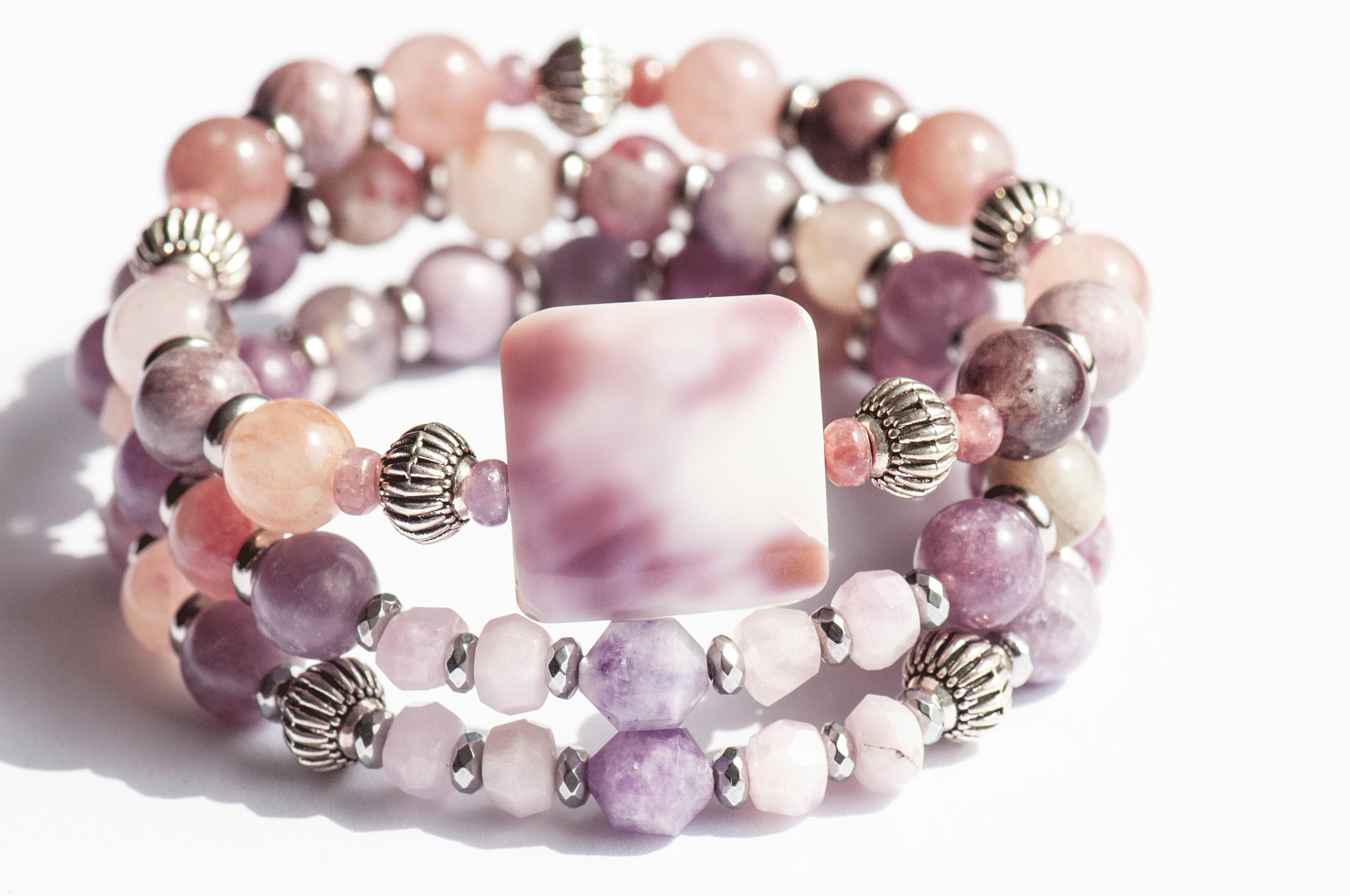 Aster September birth flower bracelet set — front view, two bracelets featuring purple cowrie shell, Berry Quartz, Mauve Jasper and Lepidolite in warm mauve tones