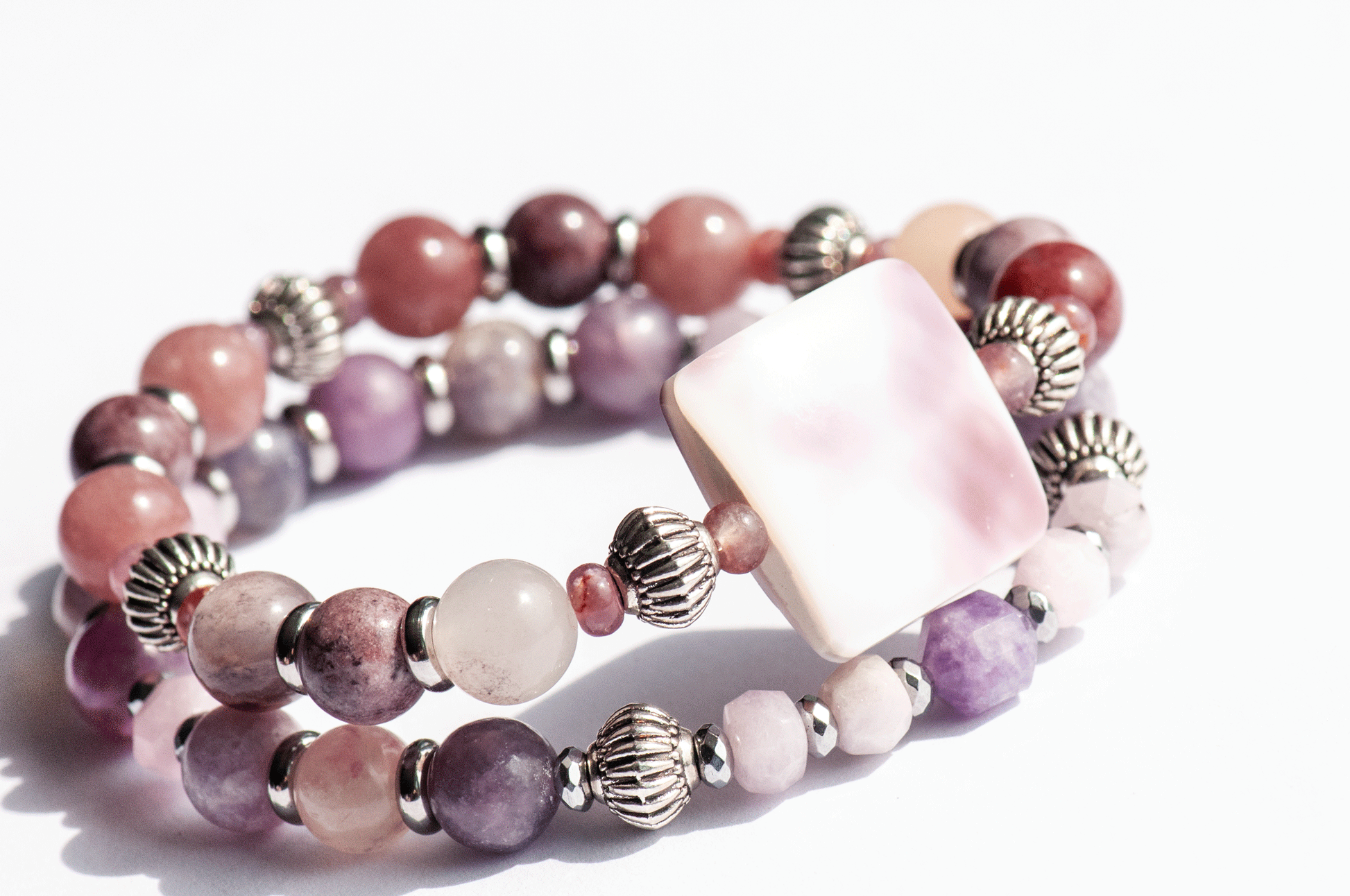 Aster September birth flower bracelet set — side view, two bracelets showing depth and layering of mauve and purple gemstone rounds