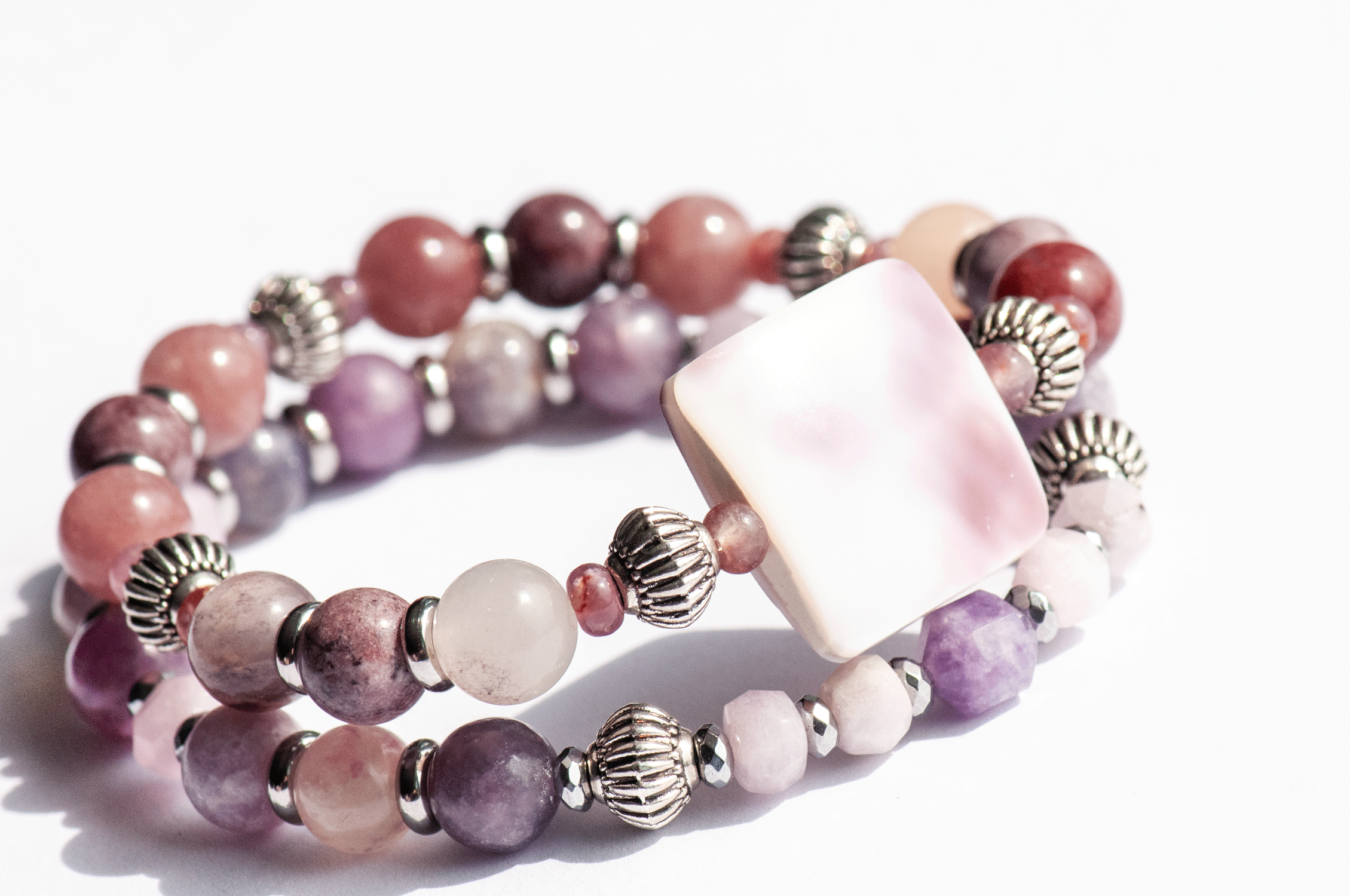 Aster September birth flower bracelet set — side view, two bracelets showing depth and layering of mauve and purple gemstone rounds