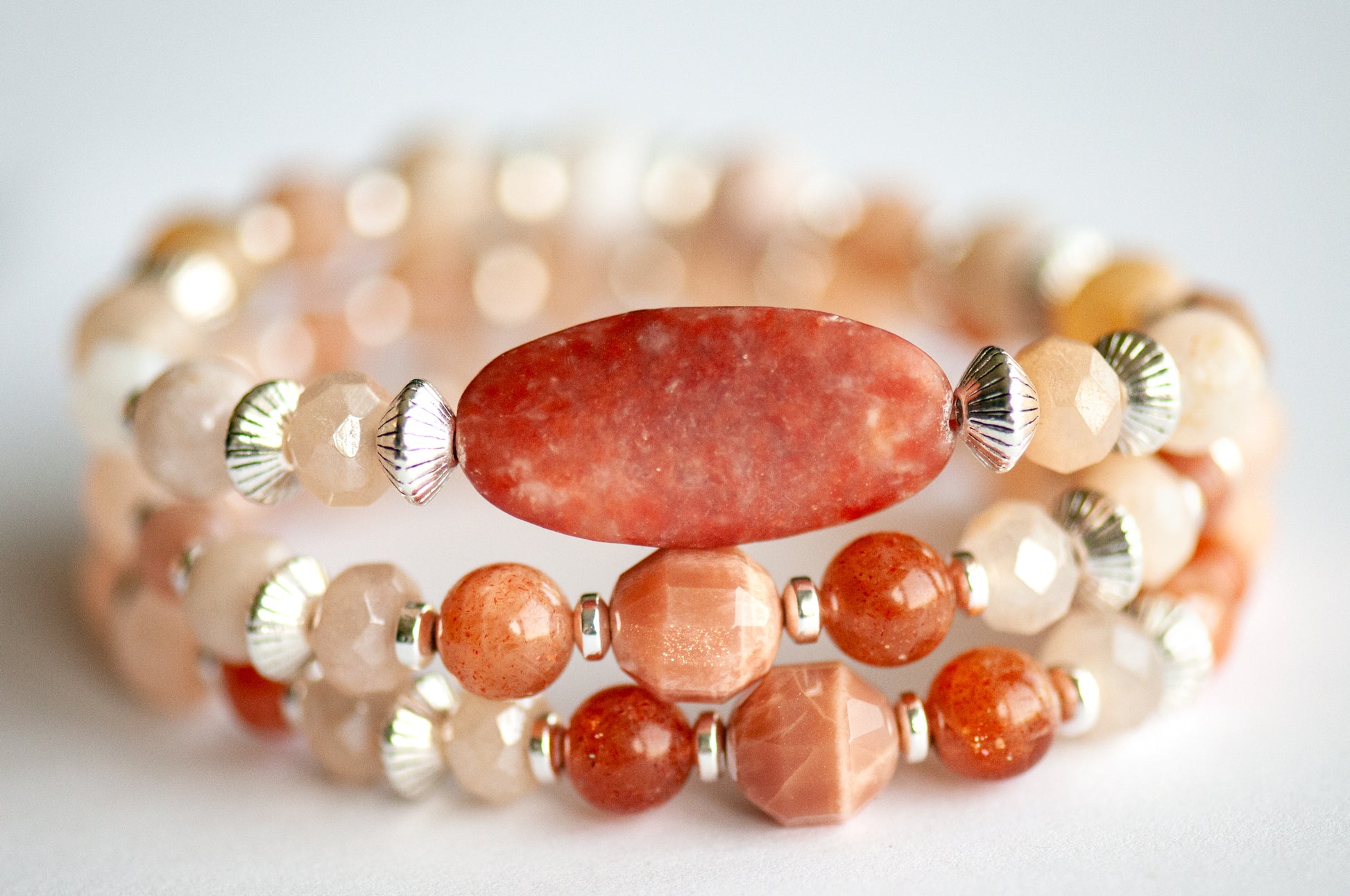 Chrysanthemum November birth flower bracelet set — front view, triple stack with two supporting bracelets featuring Peach Moonstone energy prism, Golden Sunstone and Peach Chalcedony