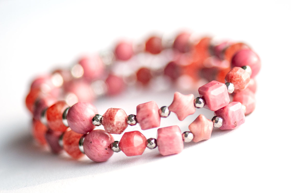 Carnation January birth flower supporting bracelet — front view, Pink Petrified Rhodonite carved star focal framed by Rhodonite table-cut cubes and Sakura Lodolite Quartz rounds