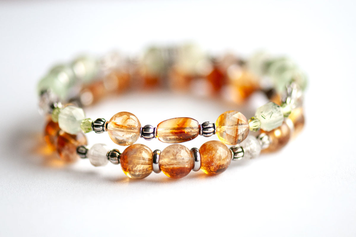 Daffodil March birth flower two-bracelet set with dark golden Citrine, green Prehnite, Peridot and Lodalite Quartz on a white background