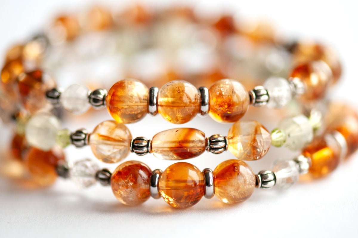 Daffodil March birth flower three-bracelet stack in whiskey-gold Citrine and spring green Prehnite, Peridot and Lodalite Quartz on a white background