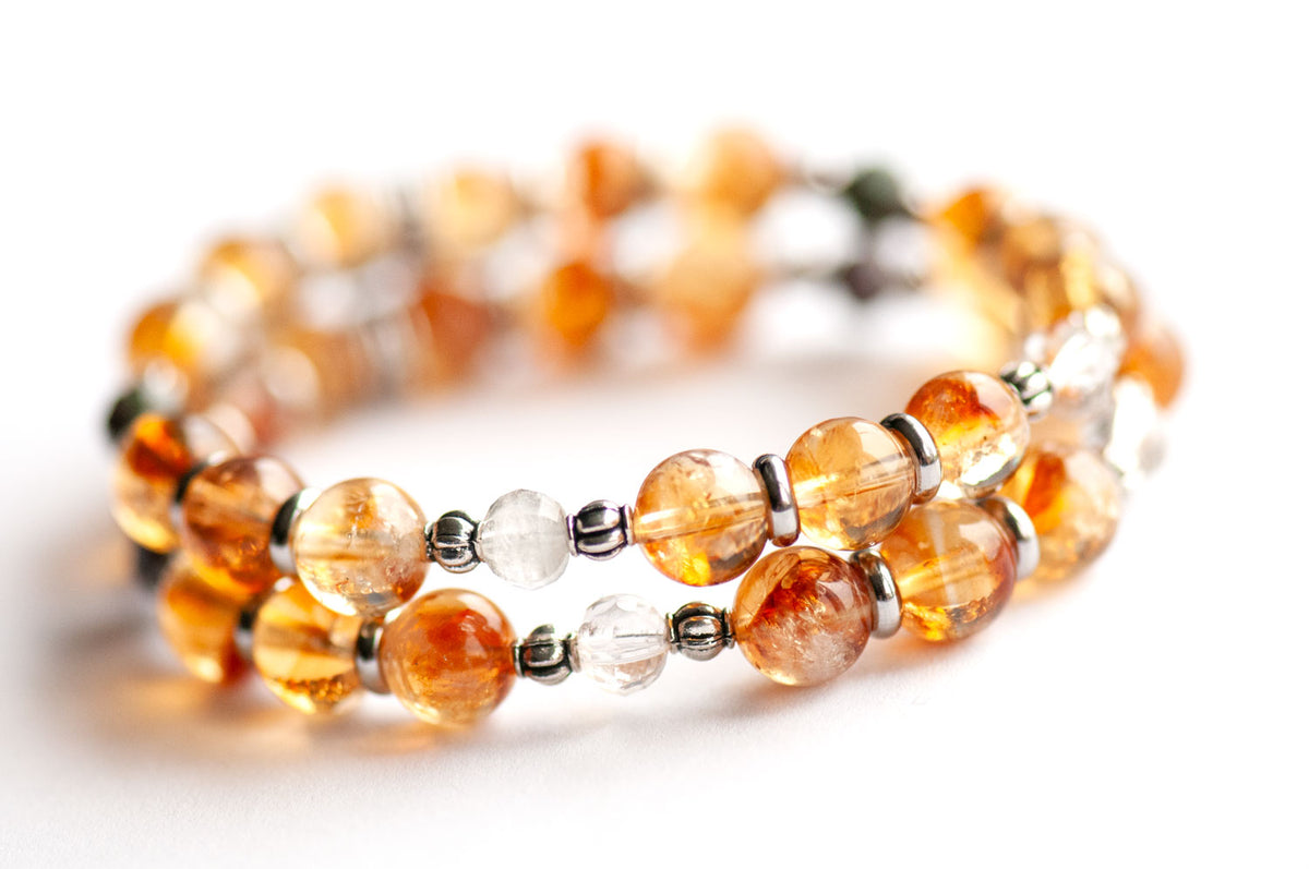 Daffodil supporting bracelets of dark golden 8mm Citrine rounds with green Lodalite Quartz lanterns and silver-tone spacers