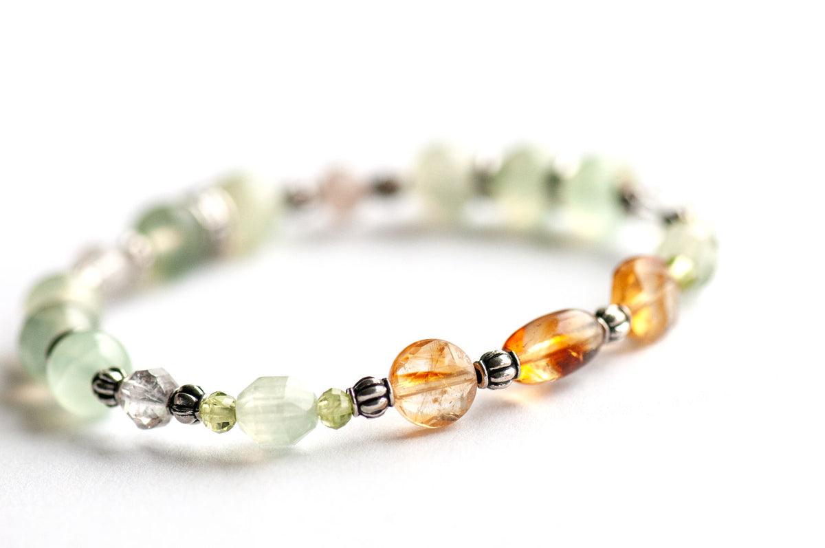 Daffodil focal bracelet with a Citrine rice bead, faceted Citrine coins, Prehnite Energy Prisms framed by Peridot, Lodalite Quartz lanterns and Prehnite rounds