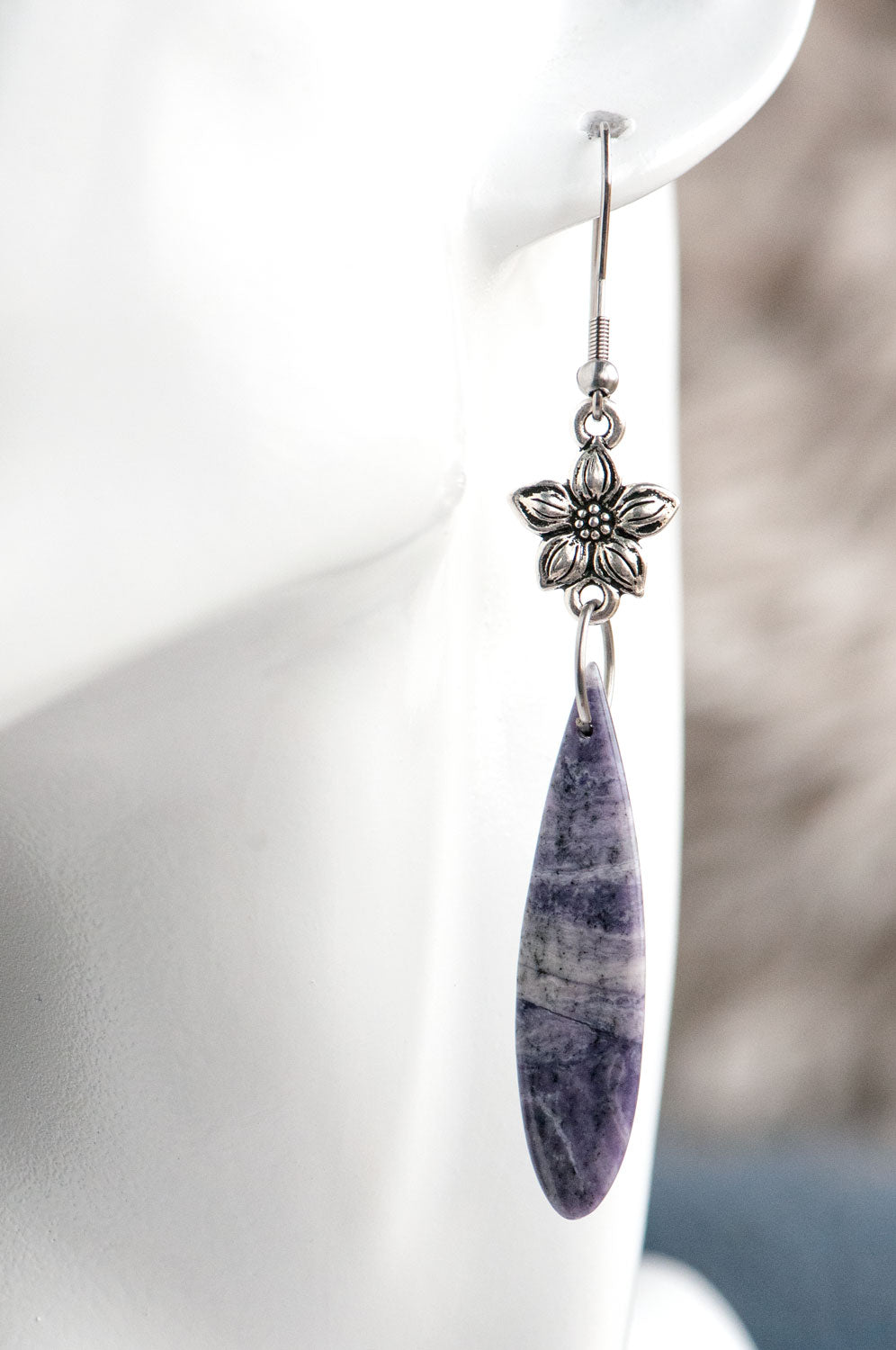 Purple opal teardrop earrings worn on the ear, showing the 8 cm total length