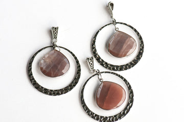 Three Mocha Lynx pendants, each a faceted Chocolate Moonstone pear in a silver bezel with a hammered silver ring and infinity-motif bail.