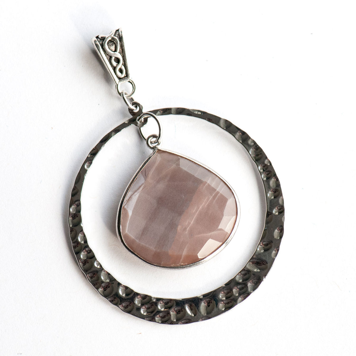 Close-up of a Mocha Lynx pendant showing the soft sheen and banding of the Chocolate Moonstone in a hammered silver ring.