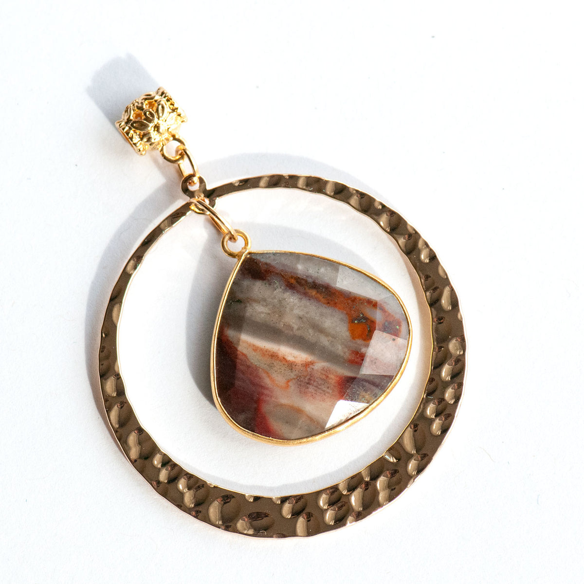 Fireside Lynx - Polychrome Jasper Pendant with Customizable Chain featuring a teardrop-shaped Polychrome Jasper pendant hanging inside a hammered gold-tone circular frame.