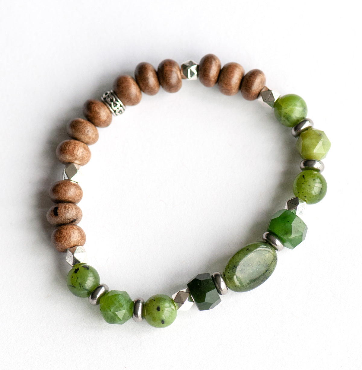Feature bracelet from British Columbia Lynx Set – BC Jade oval focal with hand-cut rondelles, star-cut and round beads, grey wood accents, and silver spacers