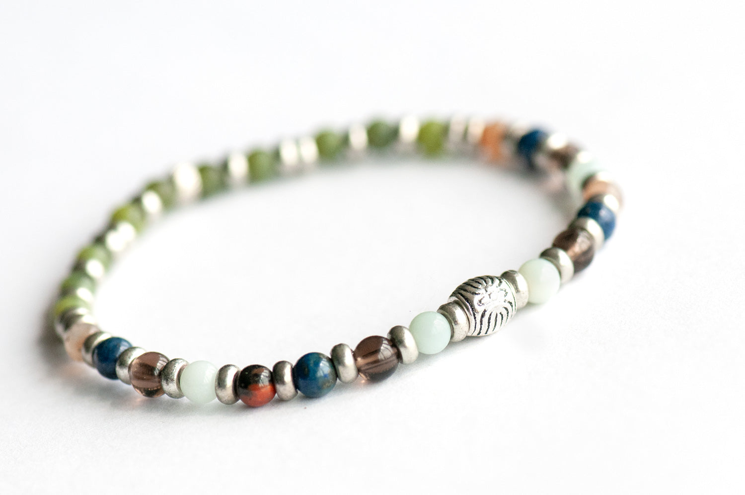 Supporting bracelet from British Columbia Lynx Set – 4mm stones with charm, including Amazonite, Smoky Quartz, Petrified Wood, Lapis Lazuli, and BC Jade