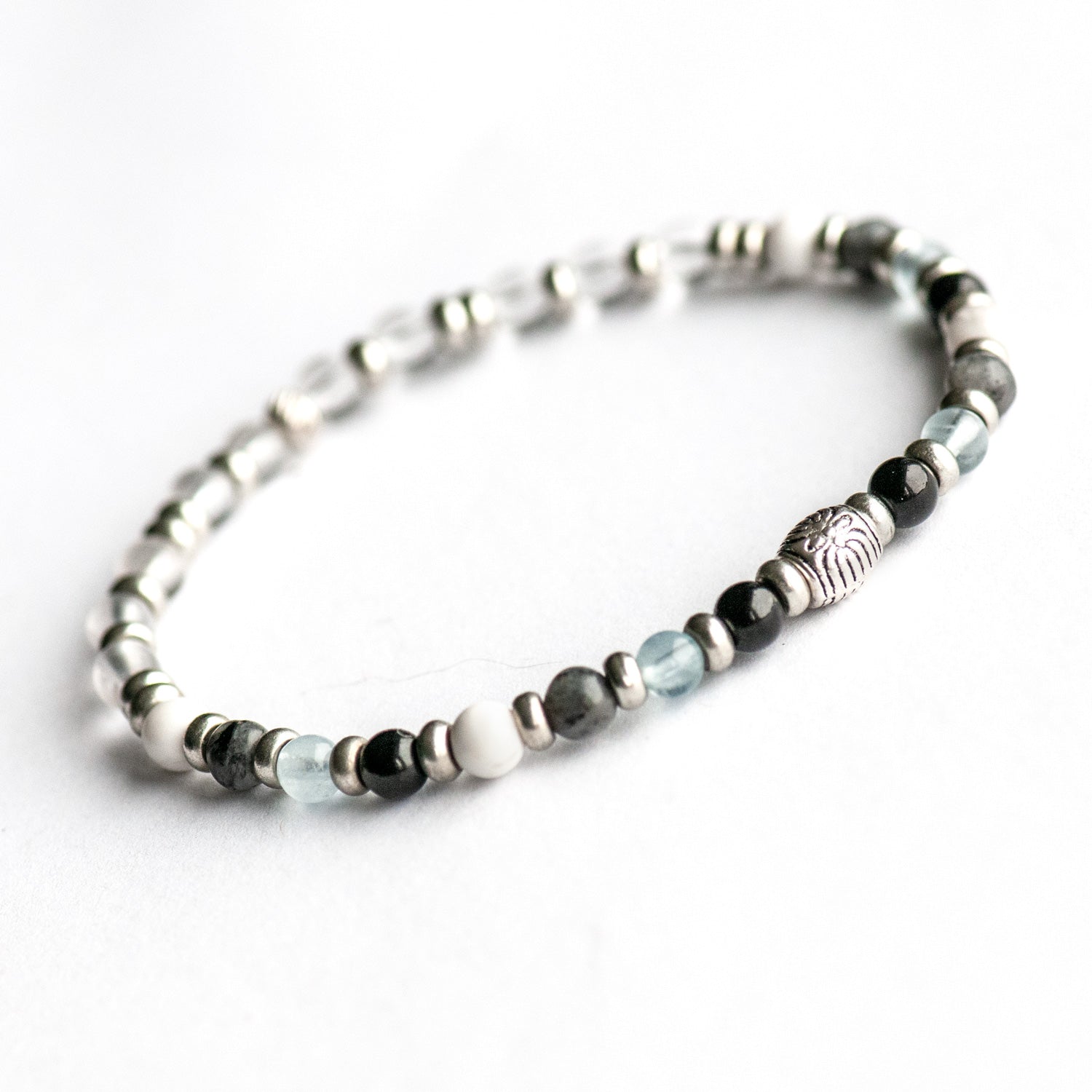 Supporting bracelet from Northwest Territories Lynx Set – 4mm stones with charm, including Black Tourmaline, Howlite, Aquamarine, Larvikite, and Quartz