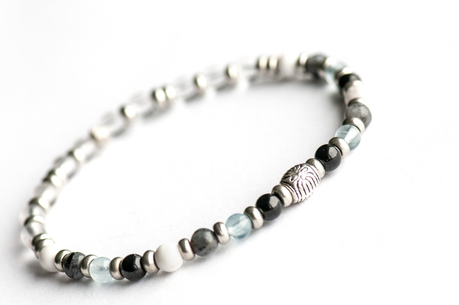 Supporting bracelet from Northwest Territories Lynx Set – 4mm stones with charm, including Black Tourmaline, Howlite, Aquamarine, Larvikite, and Quartz