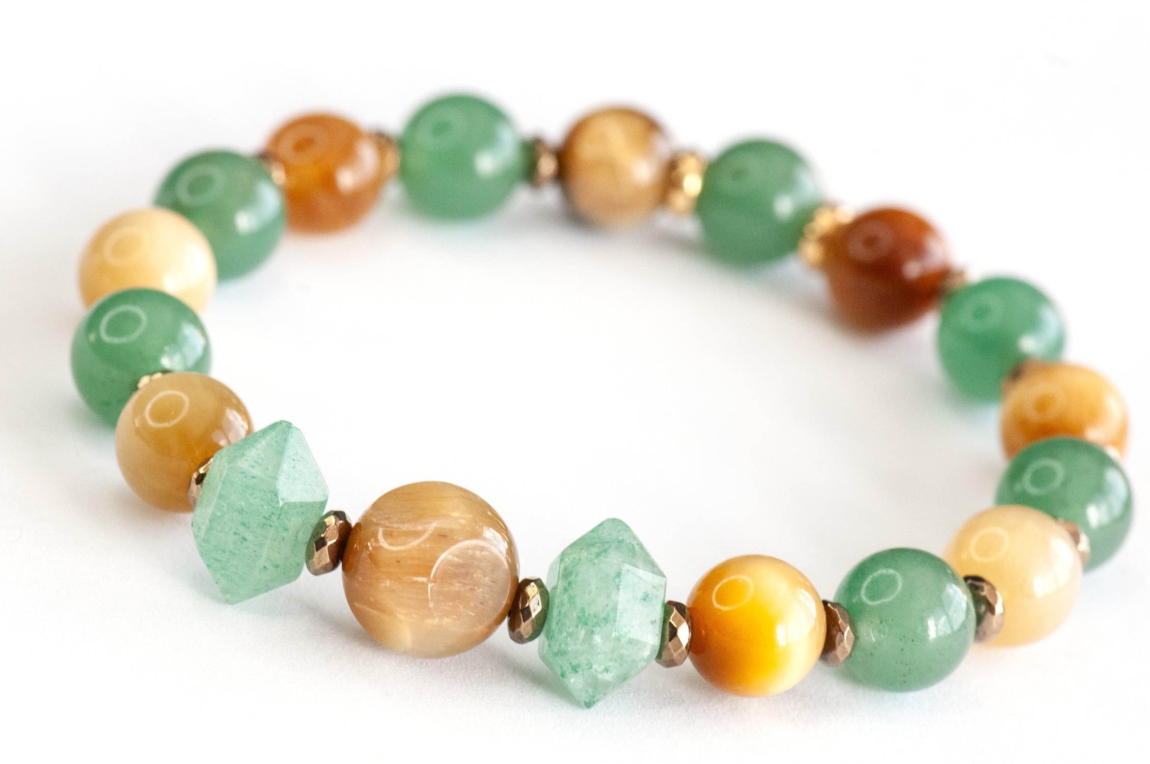 Close-up of Fierce Earth focal bracelet showing Golden Tiger Eye cube and Green Aventurine gemstone details
