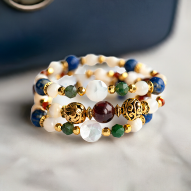 sitting on a stone countertop beside an elegant navy handbag