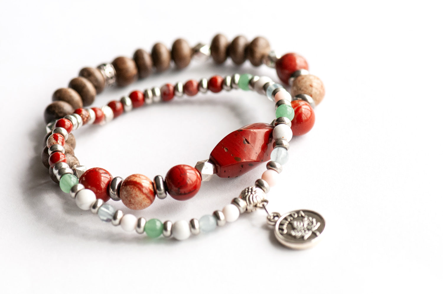 Prince Edward Island Lynx Bracelet Set – Two handmade gemstone bracelets featuring Red Jasper, Queen Conch Shell, and customizable charm options