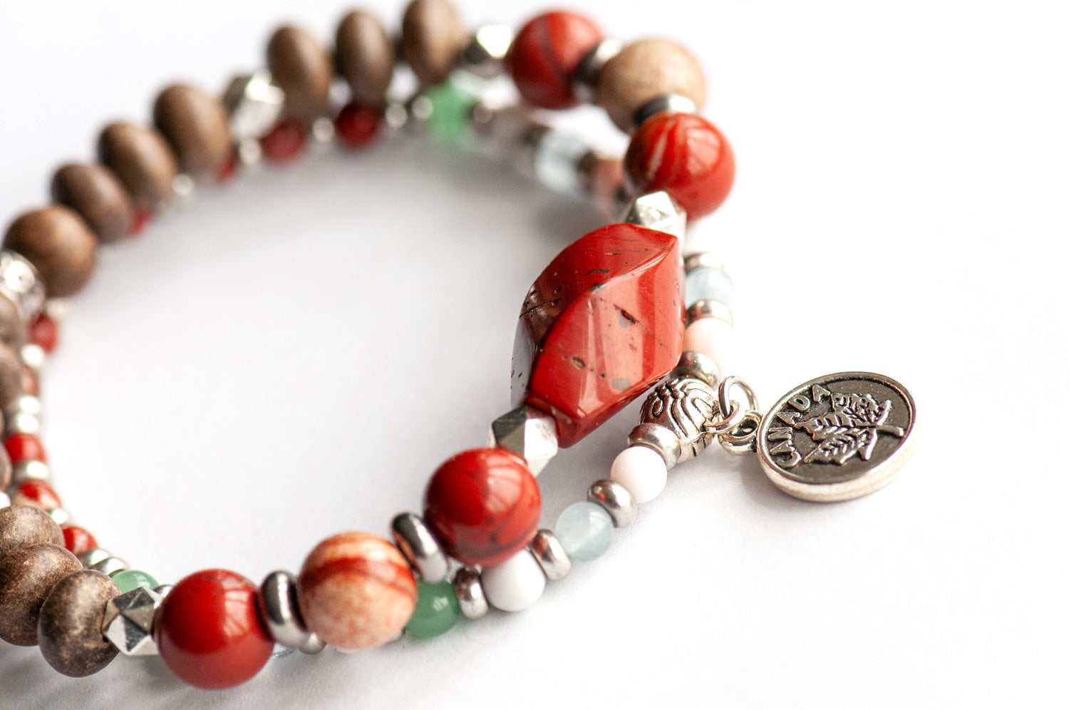 Prince Edward Island Lynx Bracelet Set – Two handmade gemstone bracelets featuring Red Jasper, Queen Conch Shell, and customizable charm options