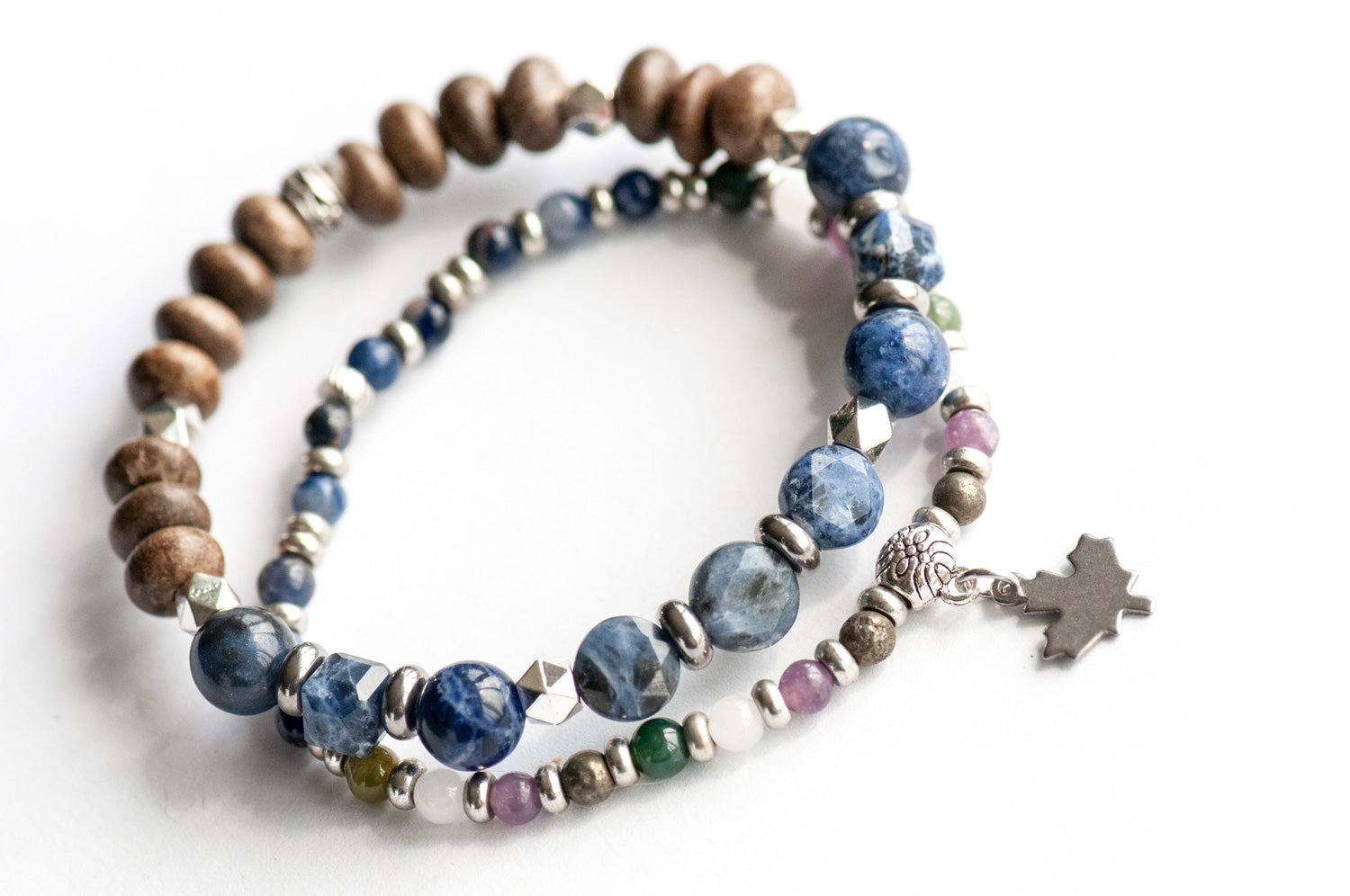 Quebec Lynx Bracelet Set – Two handmade gemstone bracelets featuring Sodalite, Pyrite, White Jade, and customizable charm options
