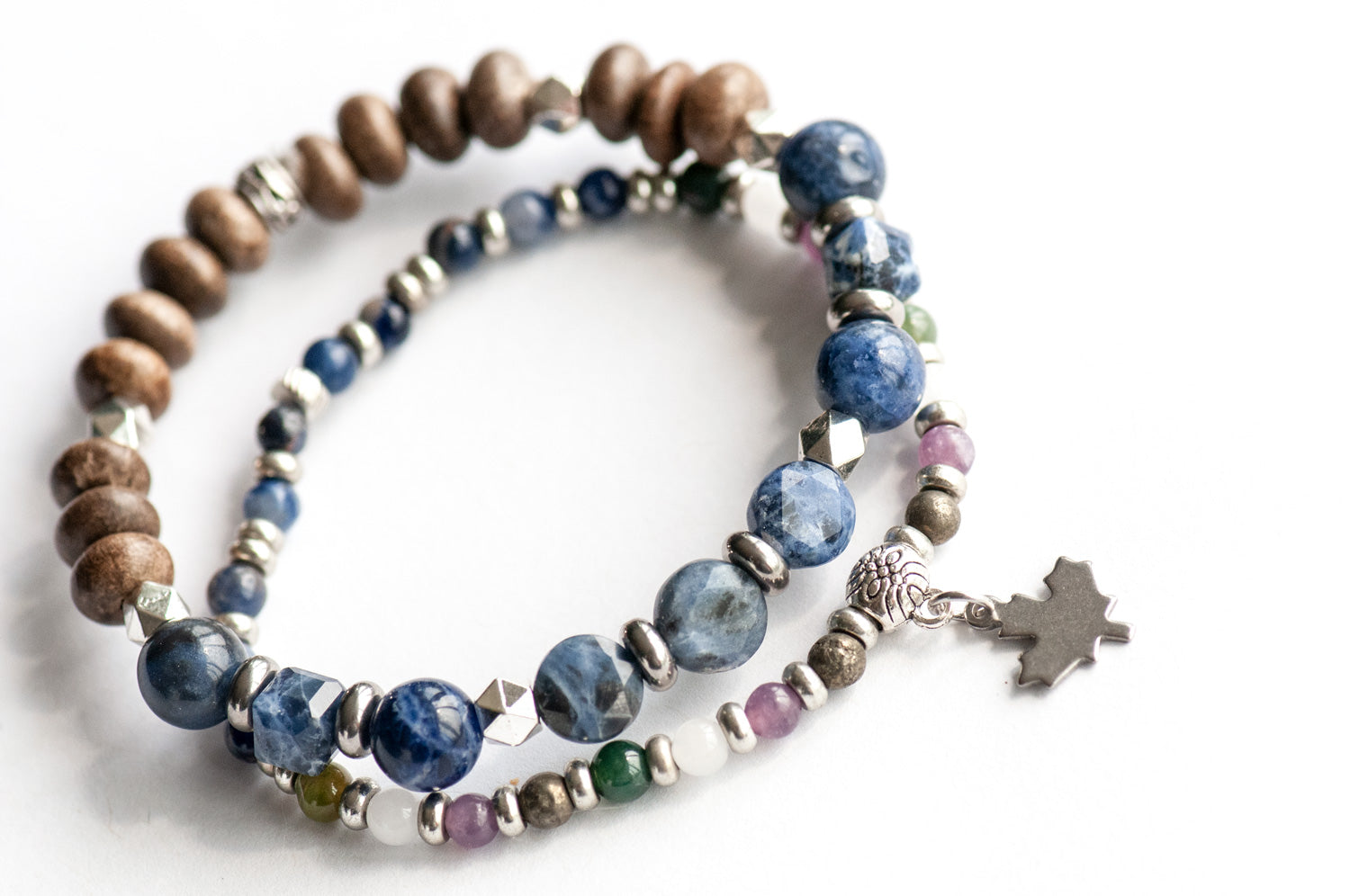 Quebec Lynx Bracelet Set – Two handmade gemstone bracelets featuring Sodalite, Pyrite, White Jade, and customizable charm options