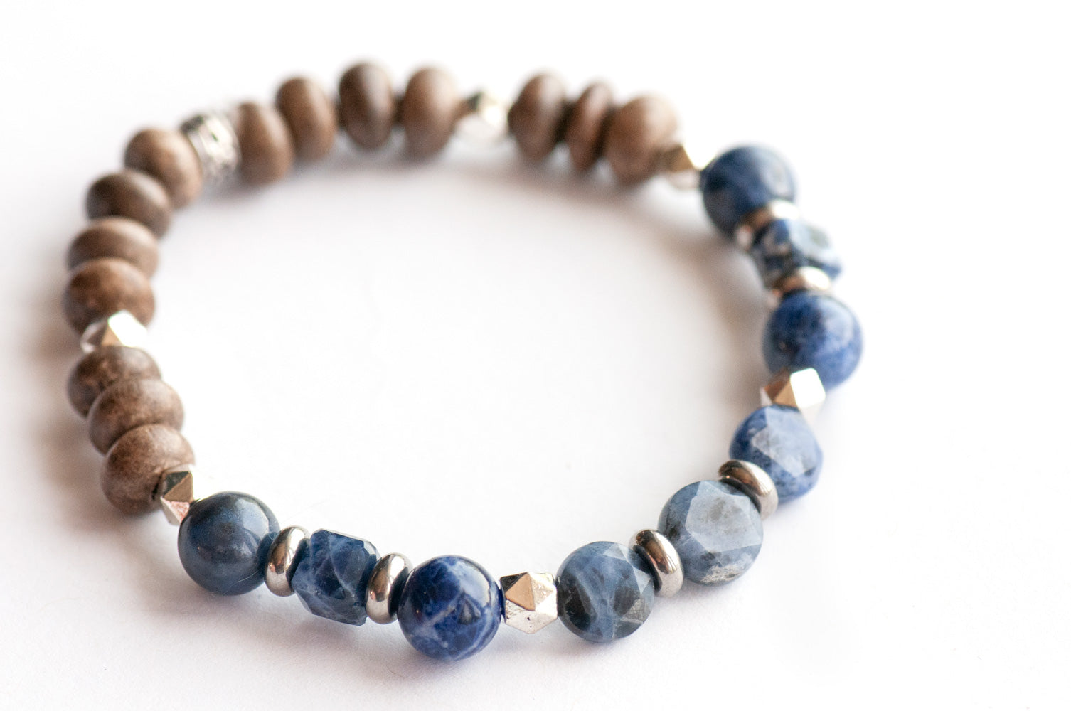 Feature bracelet from Quebec Lynx Set – Sodalite star-cut coins, cubes, and A-grade rounds with grey wood beads and silver spacers