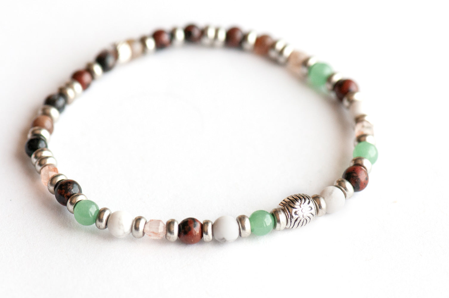 Supporting bracelet from Saskatchewan Lynx Set – 4mm stones with charm, including Green Aventurine, Mahogany Obsidian, White Howlite, Sunstone prisms, and Petrified Wood Agate