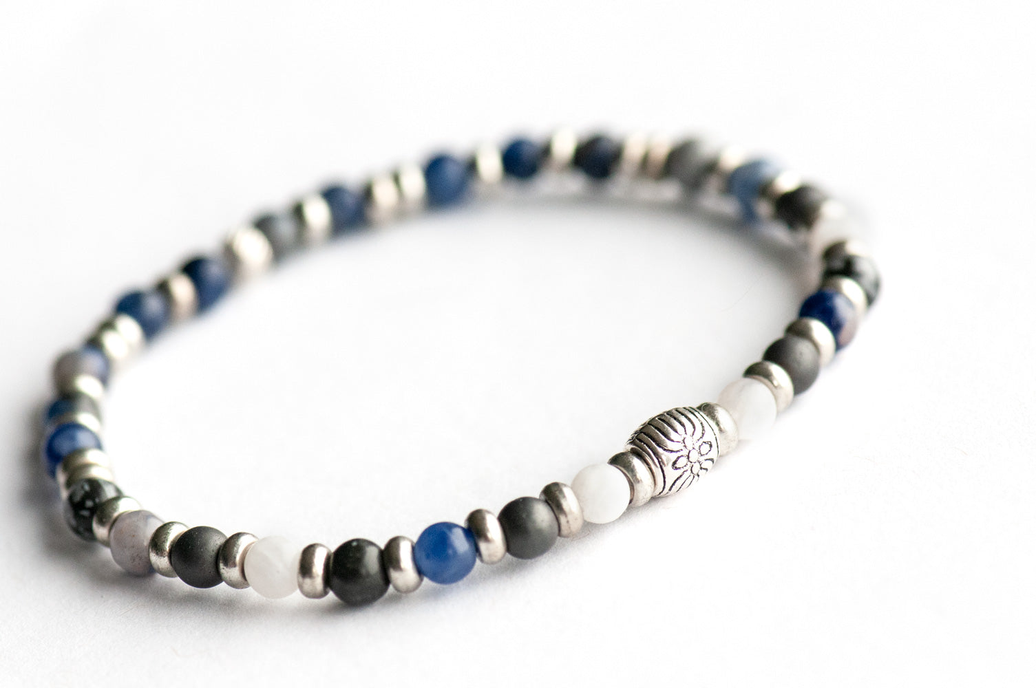 Supporting bracelet from Yukon Lynx Set – 4mm stones with charm, including Snowflake Obsidian, White Moonstone, Sodalite, Hematite, and Dumortierite