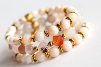 Natural shell and cherry blossom agate beads feature in this handmade bracelet set