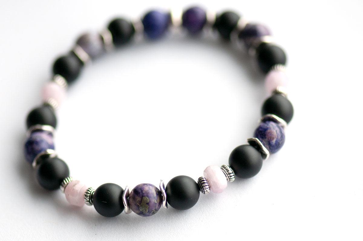 Bracelet featuring Charoite composite bead, black onyx, and kunzite beads. 