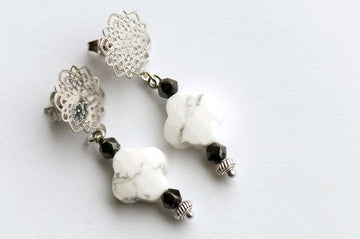 Howlite and Black Spinel pair with silver accents to form these handmade dangle stud earrings.