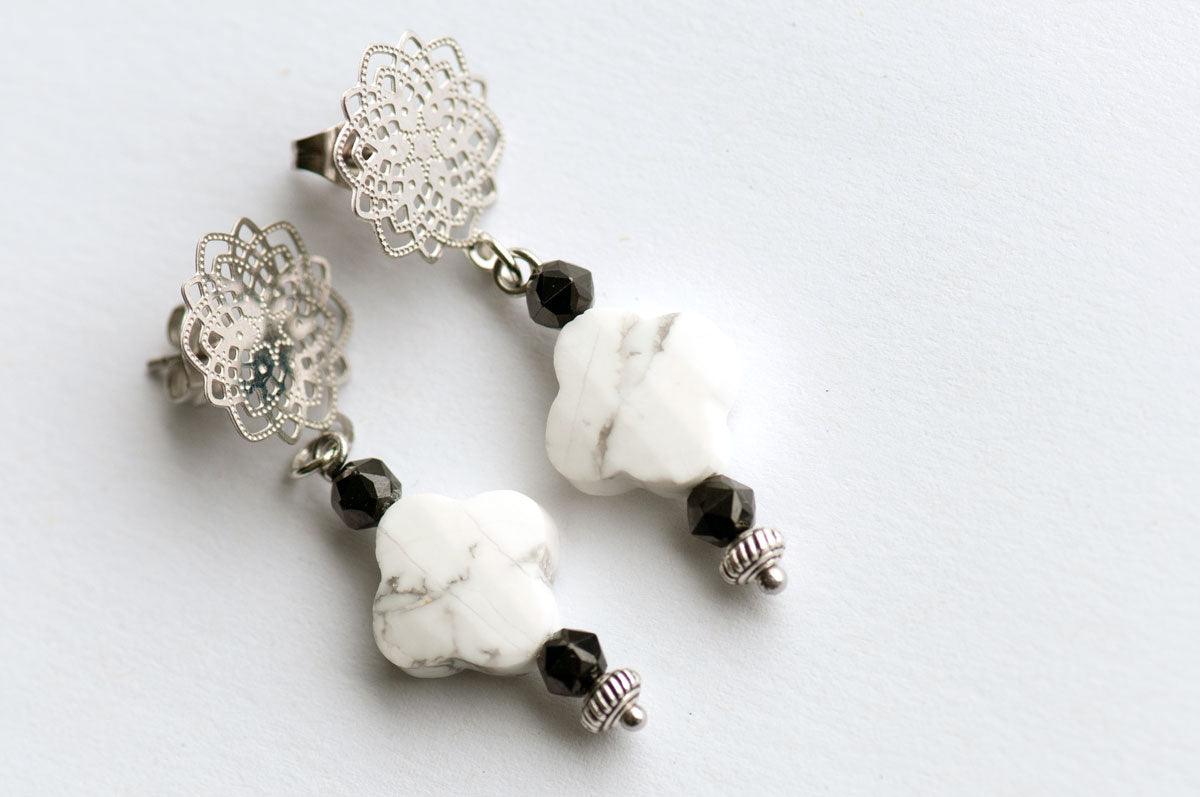 Howlite and Black Spinel pair with silver accents to form these handmade dangle stud earrings.