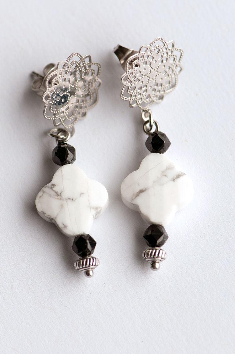 Howlite and Black Spinel pair with silver accents to form these handmade dangle stud earrings.